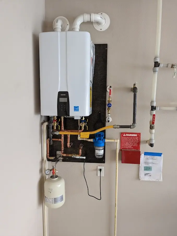 Professional plumber installing copper piping in a Old Stine home